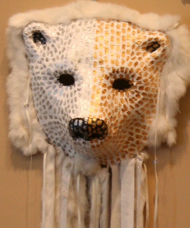A painted polar bear mask made of plaster gauze strips