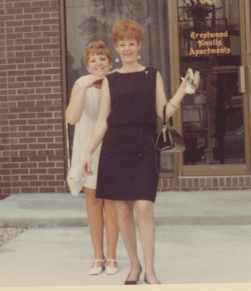 In 1968, two red-heads, a mom and daughter, are dressed up in front of their apartment building.