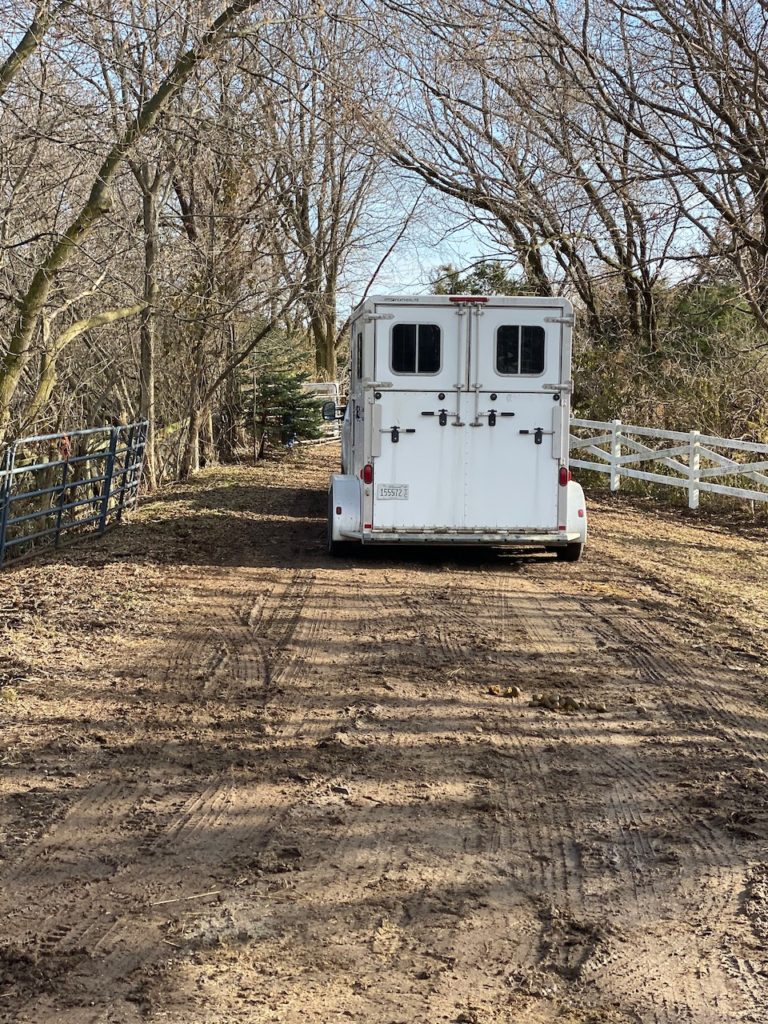 A horse trailer leaving the farm where the horses needing adoption lived.