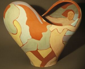 Ceramic heart form cut by infinity symbol with colored slip surface