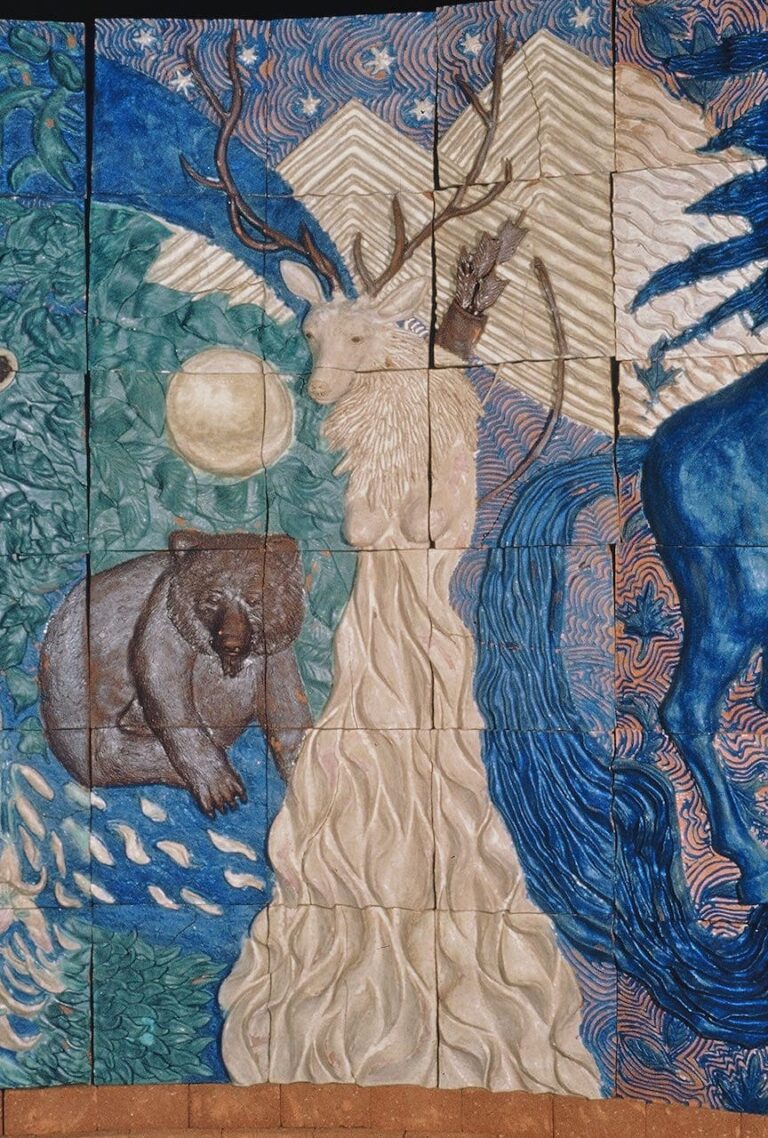 High relief ceramic tile wall depicting the mythological goddess Artimus with an elk's head and a bear at her side head